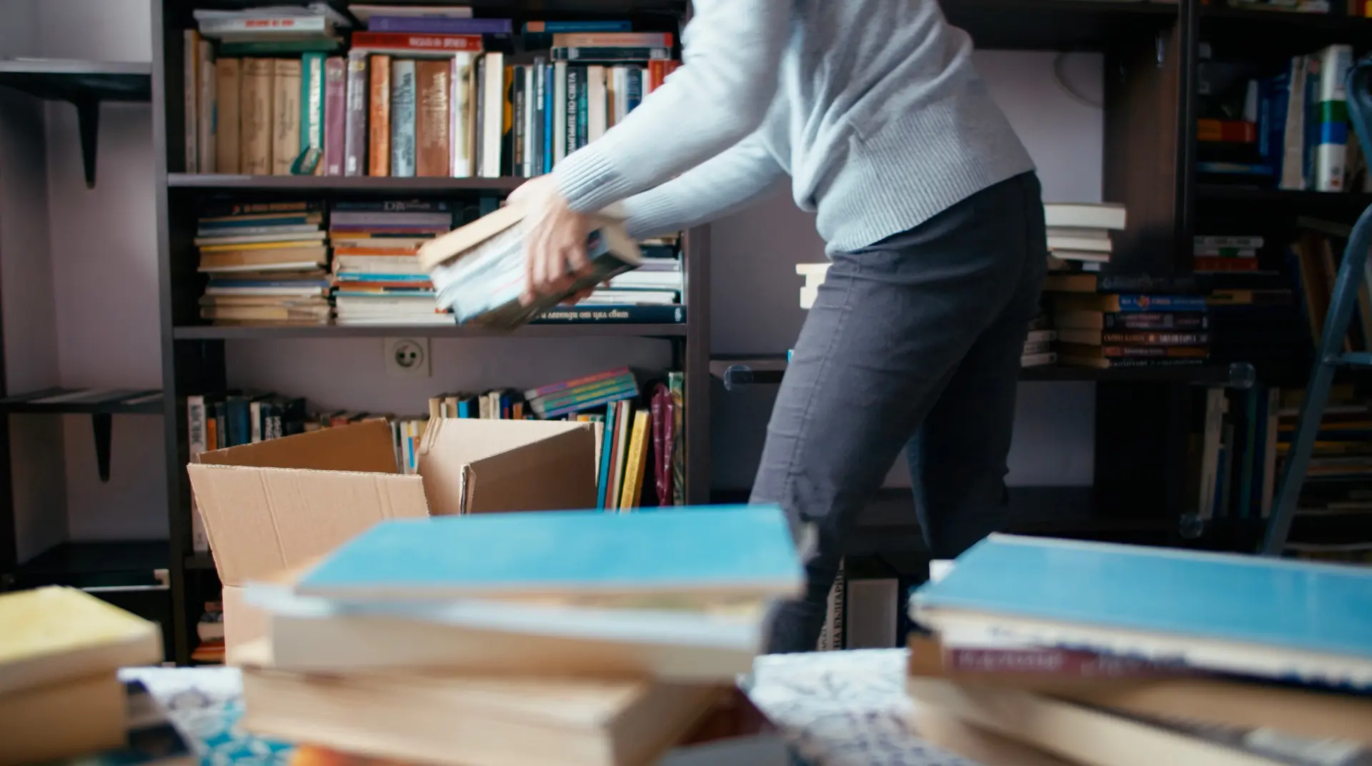 Person organizing books for donation